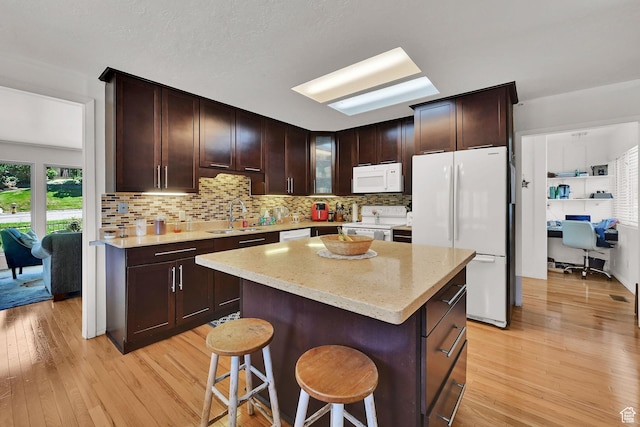 4445 Fillmore Ave, Ogden, UT 84403 - kitchen with white appliances, light wood-type flooring, and tasteful backsplash