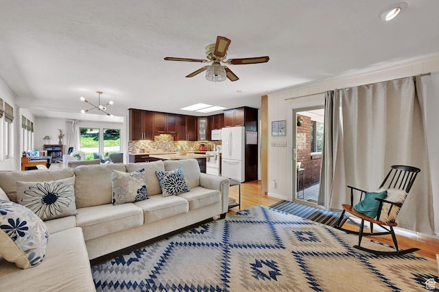 4445 Fillmore Ave, Ogden, UT 84403 - living room with light wood-style flooring, ceiling fan, a chandelier, and recessed lighting