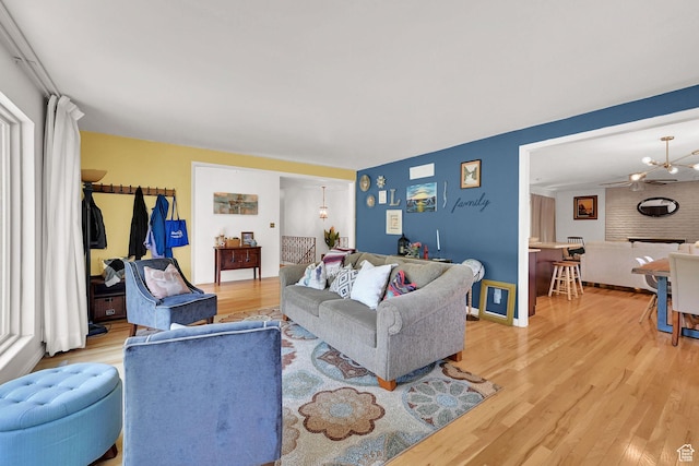 4445 Fillmore Ave, Ogden, UT 84403 - living room featuring light wood-style floors and a chandelier