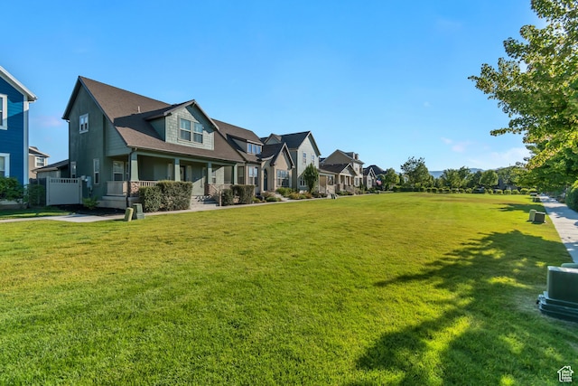 10741 S Topview Rd, South Jordan, UT 84095 - view of grassy yard featuring a residential view and covered porch