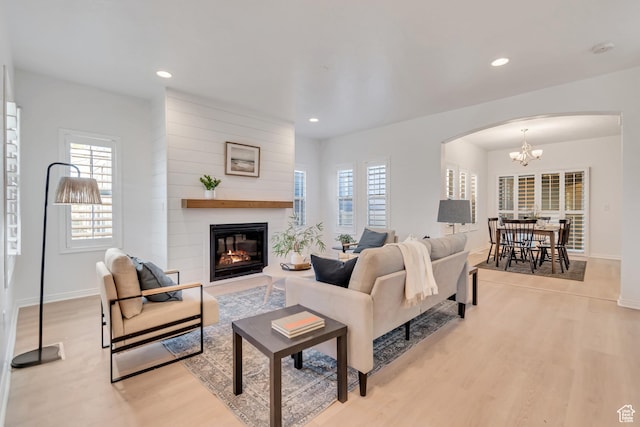 10741 S Topview Rd, South Jordan, UT 84095 - living area with arched walkways, light wood finished floors, a large fireplace, plenty of natural light, and recessed lighting