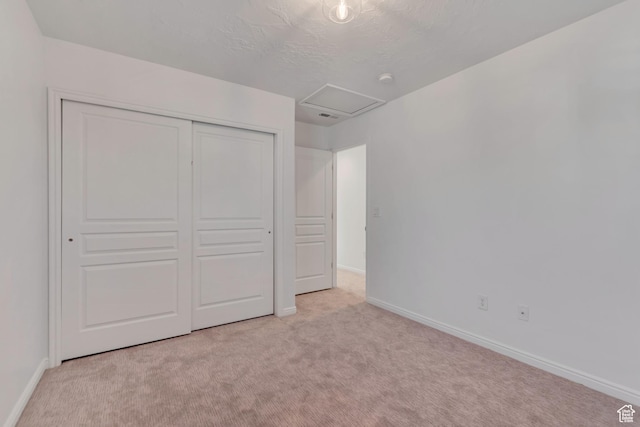10741 S Topview Rd, South Jordan, UT 84095 - unfurnished bedroom featuring carpet, attic access, a closet, and a textured ceiling