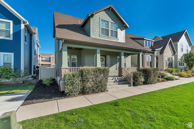 10741 S Topview Rd, South Jordan, UT 84095 - view of front facade with a porch, a front lawn, roof with shingles, and stucco siding