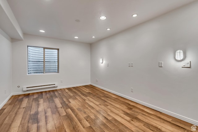 10741 S Topview Rd, South Jordan, UT 84095 - unfurnished room featuring a baseboard heating unit, recessed lighting, and wood finished floors