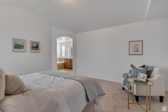 10741 S Topview Rd, South Jordan, UT 84095 - bedroom featuring vaulted ceiling, arched walkways, light colored carpet, and ensuite bath