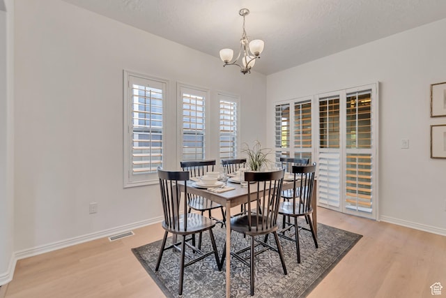 10741 S Topview Rd, South Jordan, UT 84095 - dining space featuring light wood-type flooring and a chandelier