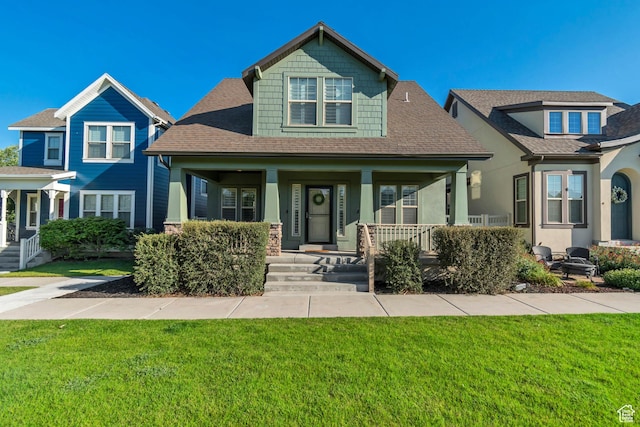 10741 S Topview Rd, South Jordan, UT 84095 - craftsman house featuring covered porch, a front lawn, and roof with shingles
