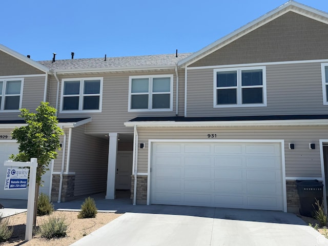 931 W 910 N, Tremonton, UT 84337 - view of front of house with stone siding, a garage, and driveway