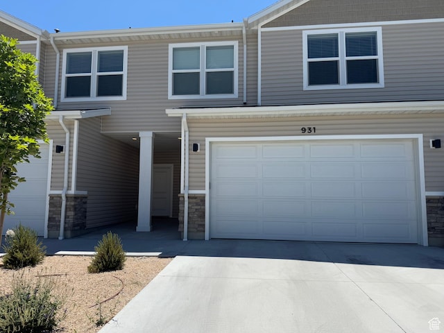931 W 910 N, Tremonton, UT 84337 - view of front of property featuring stone siding, an attached garage, and concrete driveway