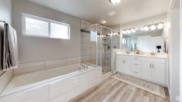 165 S 2800 E Unit 102, Spanish Fork, UT 84660 - full bathroom with a bath, double vanity, a stall shower, and wood finished floors