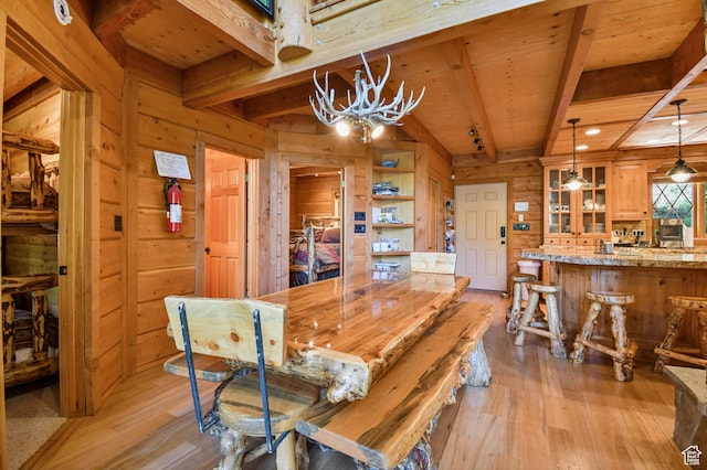 8581 Shingle Mill Dr, Oakley, UT 84055 - dining area featuring wooden walls, light wood finished floors, a wood ceiling with exposed beams, and a chandelier