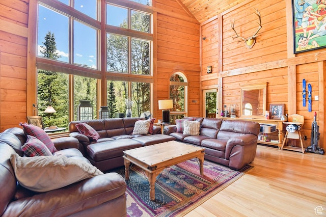 8581 Shingle Mill Dr, Oakley, UT 84055 - living area featuring high vaulted ceiling, wooden walls, wood finished floors, and wood ceiling