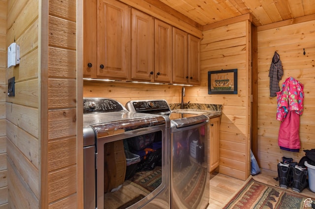 8581 Shingle Mill Dr, Oakley, UT 84055 - laundry area featuring washer and clothes dryer, cabinet space, wood ceiling, and wooden walls
