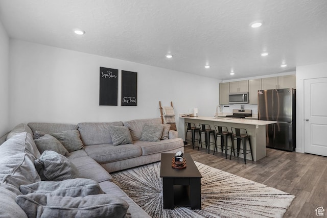8466 W Cordero Dr S, Magna, UT 84044 - living area with wood finished floors and recessed lighting