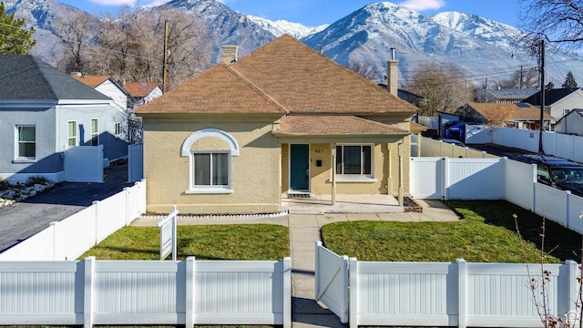 461 S 400 W, Provo, UT 84601 - view of front facade with brick siding, a fenced backyard, a chimney, covered porch, and roof with shingles