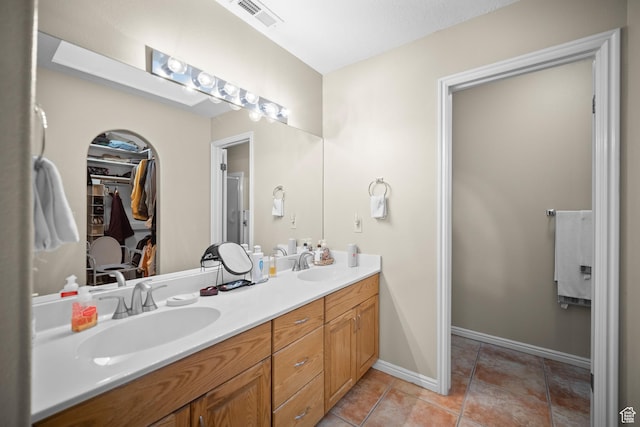 845 N Valley View Dr Unit 917, St George, UT 84770 - bathroom featuring double vanity, a walk in closet, and tile patterned flooring