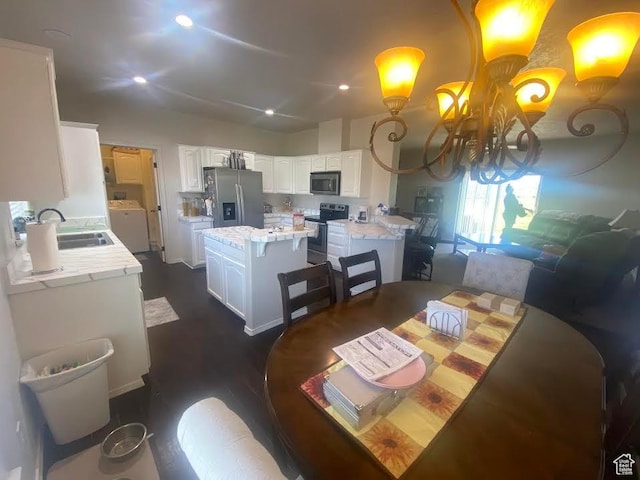 6689 W 7625 S, Myton, UT 84052 - dining room with washer / dryer, a chandelier, dark wood-style flooring, and recessed lighting