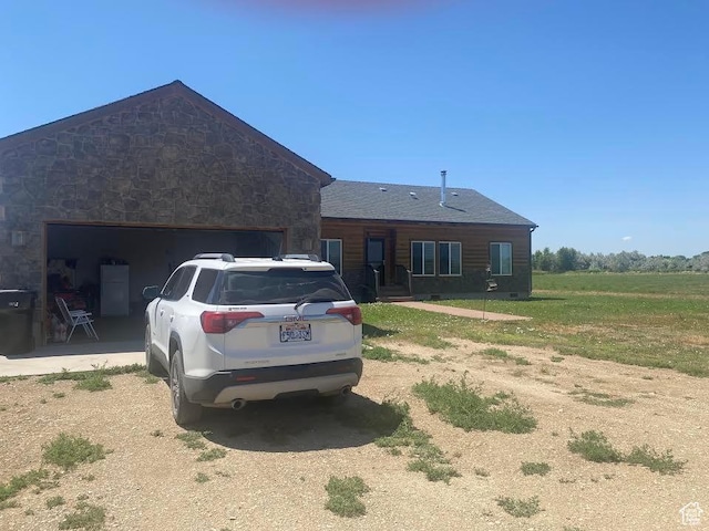 6689 W 7625 S, Myton, UT 84052 - view of front of house with driveway, a garage, and stone siding
