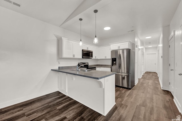 14708 S Astin Ln Unit 302, Herriman, UT 84096 - kitchen featuring stainless steel appliances, a peninsula, dark countertops, white cabinetry, and recessed lighting