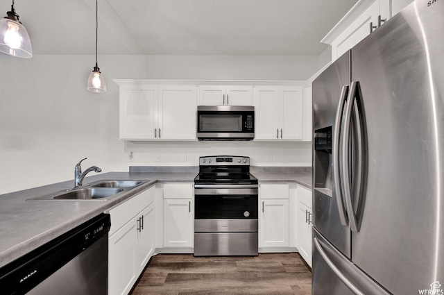 14708 S Astin Ln Unit 302, Herriman, UT 84096 - kitchen with stainless steel appliances, dark wood finished floors, white cabinetry, and decorative light fixtures
