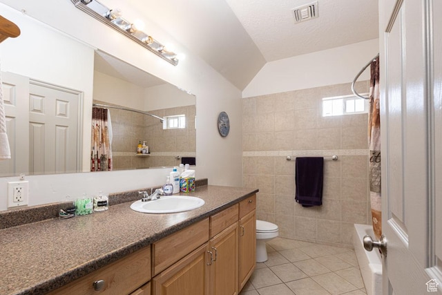 1444 N 3775 W, Cedar City, UT 84721 - full bathroom with vanity, tile patterned flooring, tile walls, shower / bath combo with shower curtain, and vaulted ceiling