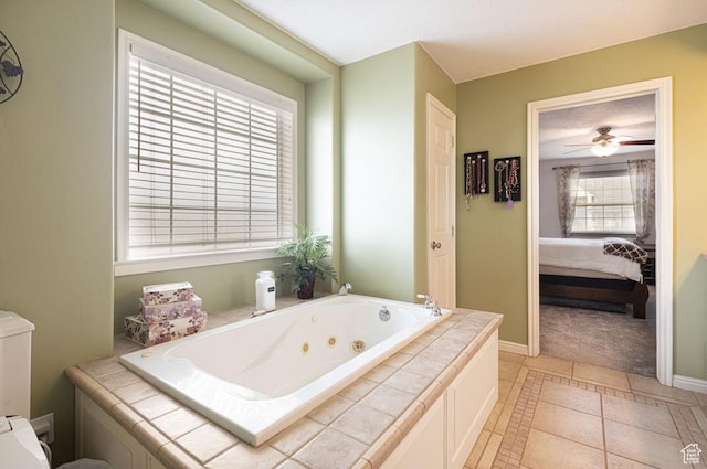 1444 N 3775 W, Cedar City, UT 84721 - bathroom with a tub with jets, connected bathroom, a ceiling fan, and tile patterned floors