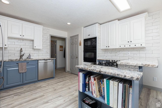 1444 N 3775 W, Cedar City, UT 84721 - kitchen with black appliances, blue cabinets, white cabinets, a textured ceiling, and recessed lighting