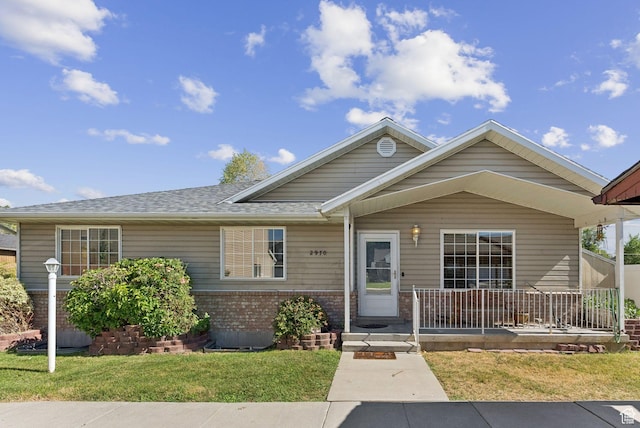 2970 W Shadow Park Dr, West Valley City, UT 84119 - view of front of property featuring brick siding, a front lawn, covered porch, and a shingled roof