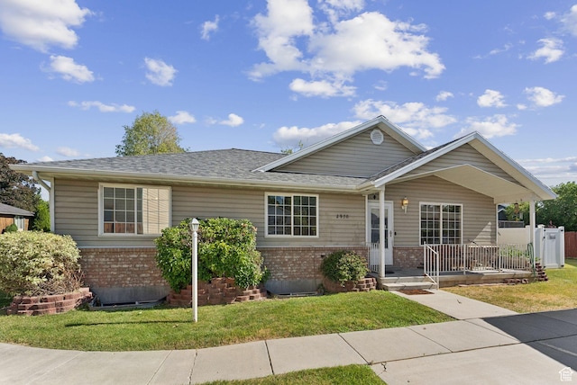 2970 W Shadow Park Dr, West Valley City, UT 84119 - ranch-style home with brick siding, a front yard, roof with shingles, and a porch