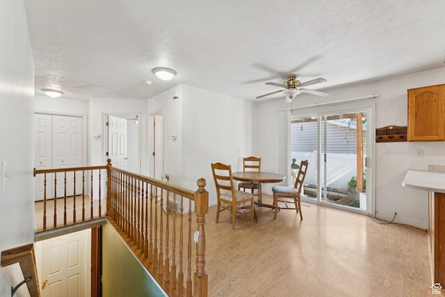 2970 W Shadow Park Dr, West Valley City, UT 84119 - dining area featuring light wood-type flooring, a ceiling fan, and a textured ceiling
