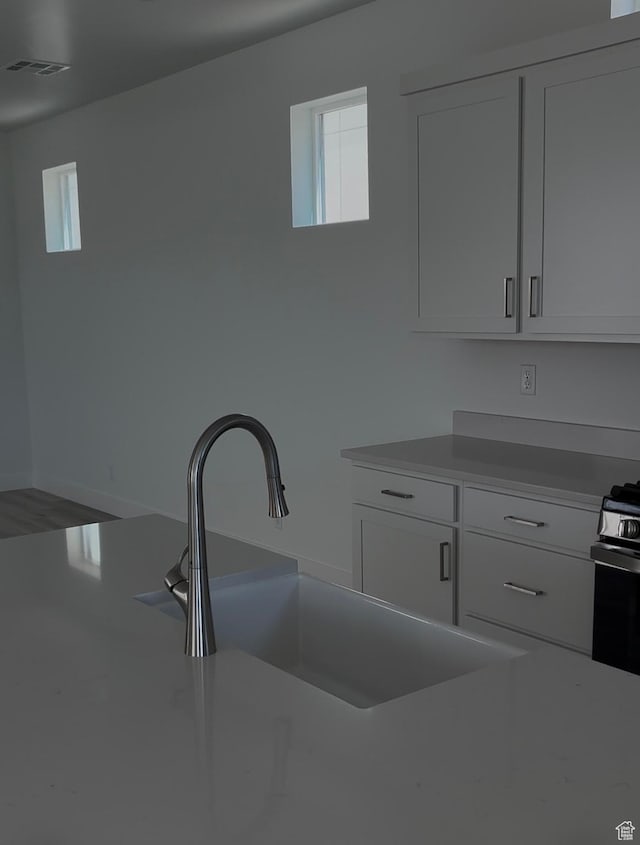 6178 S Kelly Ln, St George, UT 84790 - kitchen featuring healthy amount of natural light, white cabinets, and light countertops