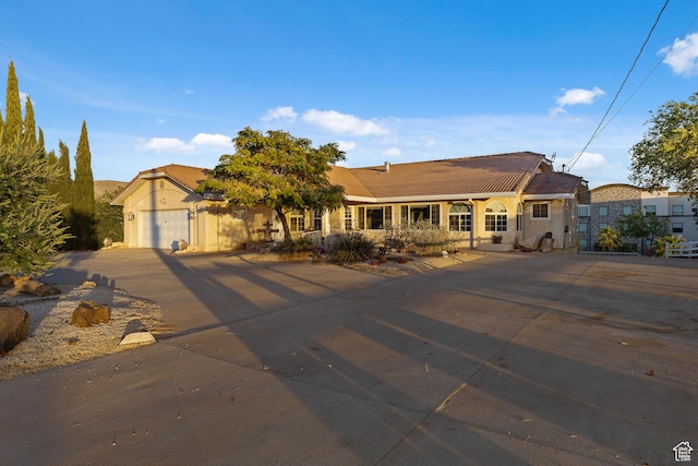 763 W 100 N, Hurricane, UT 84737 - mediterranean / spanish house with concrete driveway, a tile roof, a garage, and stucco siding