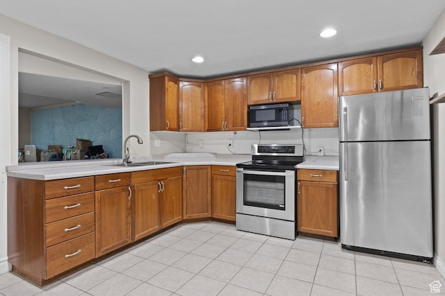 763 W 100 N, Hurricane, UT 84737 - kitchen with appliances with stainless steel finishes, brown cabinets, light countertops, light tile patterned floors, and recessed lighting