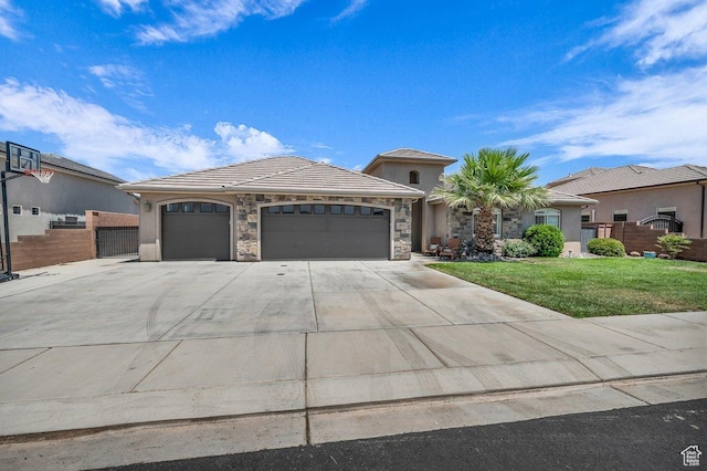 3334 W 2700 S, Hurricane, UT 84737 - view of front of house with an attached garage, stone siding, driveway, a tile roof, and stucco siding