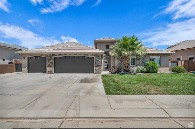 3334 W 2700 S, Hurricane, UT 84737 - view of front of property featuring driveway, a garage, stucco siding, stone siding, and a tiled roof