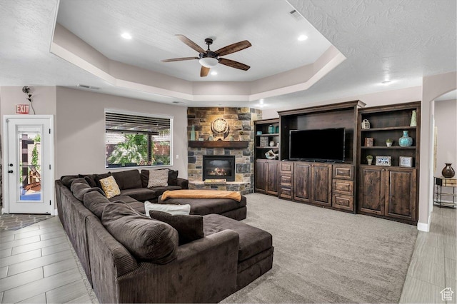 3334 W 2700 S, Hurricane, UT 84737 - living room featuring a tray ceiling, a ceiling fan, a fireplace, recessed lighting, and a textured ceiling