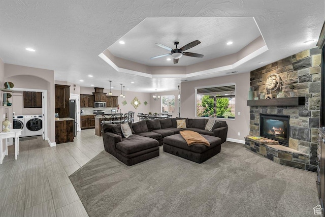 3334 W 2700 S, Hurricane, UT 84737 - living room with a ceiling fan, a fireplace, recessed lighting, a tray ceiling, and washing machine and clothes dryer