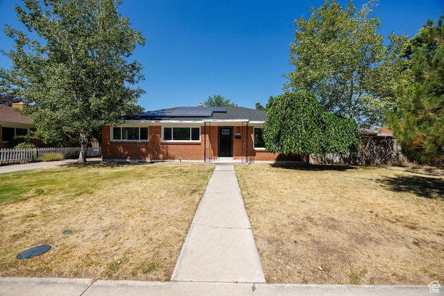 875 N 50 W, Orem, UT 84057 - view of front of house featuring roof mounted solar panels and brick siding