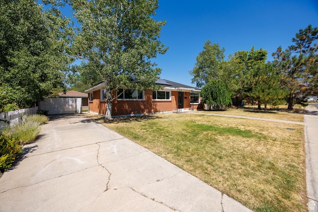 875 N 50 W, Orem, UT 84057 - view of front of house with roof mounted solar panels, brick siding, and a detached garage