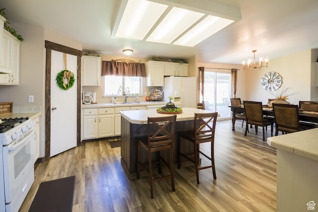 5375 N Canal Rd, Lapoint, UT 84039 - kitchen featuring white appliances, a chandelier, light countertops, and light wood-style floors
