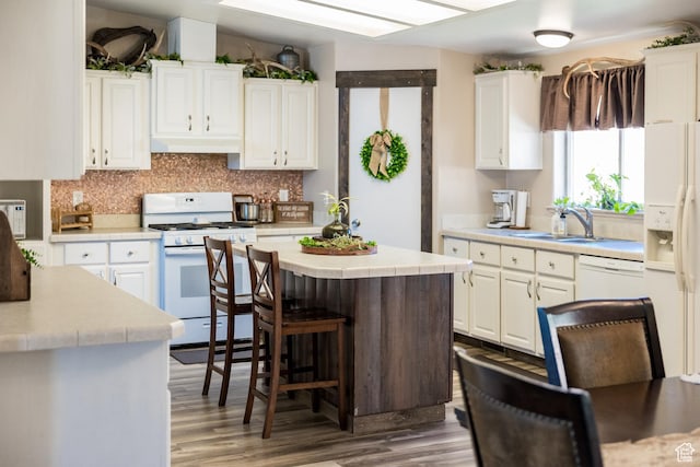5375 N Canal Rd, Lapoint, UT 84039 - kitchen featuring white appliances, under cabinet range hood, white cabinetry, and wood finished floors