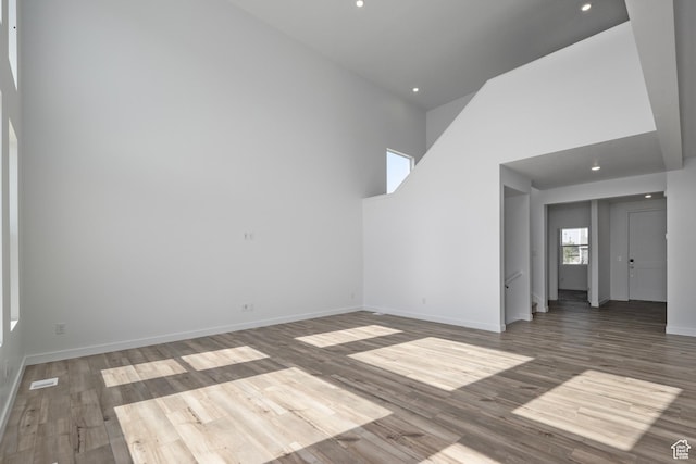 1844 E Bison Dr N Unit B229, Eagle Mountain, UT 84005 - unfurnished living room featuring wood finished floors, recessed lighting, and a high ceiling