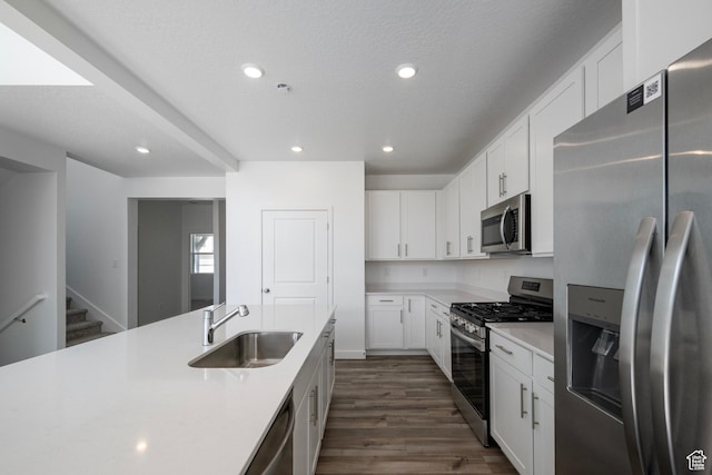 1844 E Bison Dr N Unit B229, Eagle Mountain, UT 84005 - kitchen with appliances with stainless steel finishes, light countertops, dark wood-style floors, white cabinetry, and recessed lighting