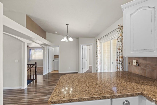 845 S 1150 E, Preston, ID 83263 - kitchen with a chandelier, backsplash, dark wood finished floors, white cabinetry, and hanging light fixtures