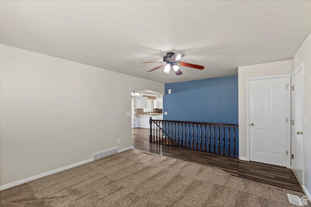 845 S 1150 E, Preston, ID 83263 - unfurnished room featuring a ceiling fan, arched walkways, carpet, and a textured ceiling
