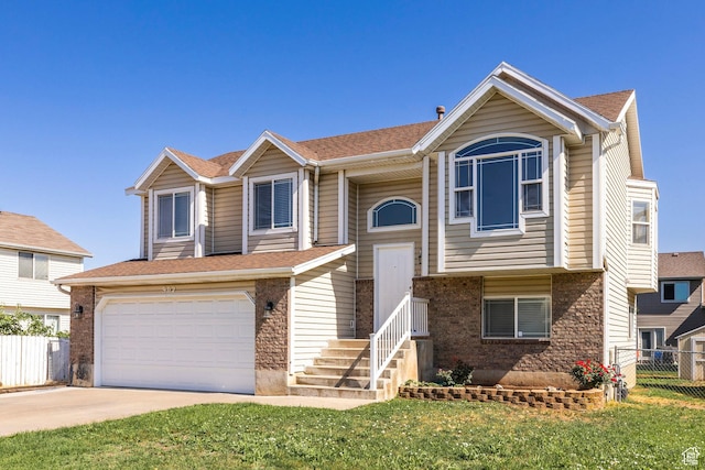902 W 4200 S, Riverdale, UT 84405 - raised ranch with driveway, an attached garage, brick siding, and a shingled roof
