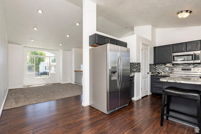 902 W 4200 S, Riverdale, UT 84405 - kitchen featuring appliances with stainless steel finishes, open floor plan, lofted ceiling, dark wood finished floors, and tasteful backsplash