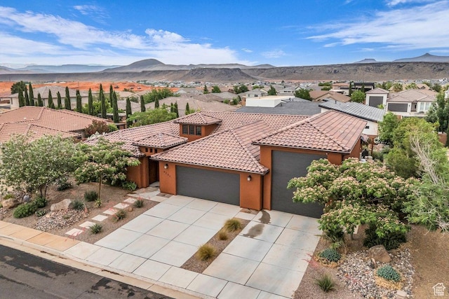 2751 S 3970 W, Hurricane, UT 84737 - view of front facade featuring a garage, a tiled roof, a mountain view, and stucco siding
