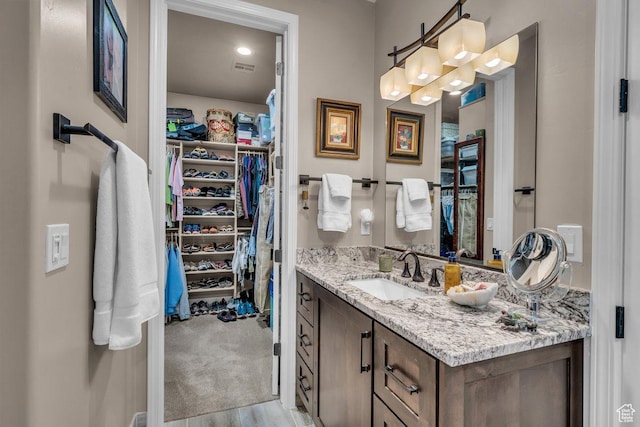 2751 S 3970 W, Hurricane, UT 84737 - bathroom featuring vanity, a spacious closet, and wood finished floors