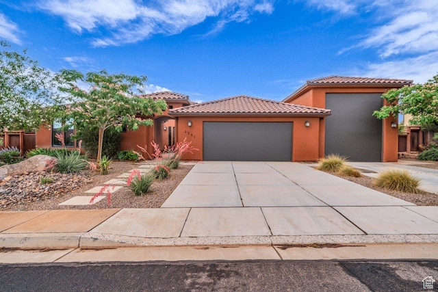 2751 S 3970 W, Hurricane, UT 84737 - view of front facade featuring an attached garage, a tile roof, stucco siding, and driveway